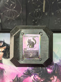 Black and iridescent 3D-printed Alter Board holding a trading card, front view