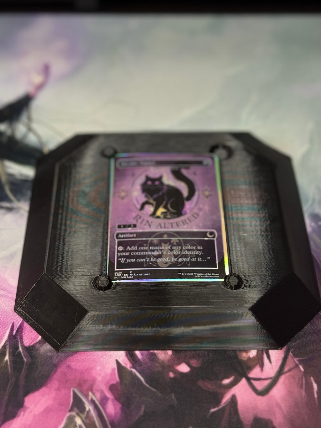 Black and iridescent 3D-printed Alter Board viewed from above with a trading card