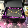 Black gift box with purple tissue and a black gold-trimmed envelope with wax seal for Alters By Rin gift cards