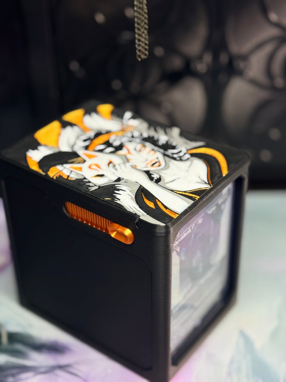 Top angle of black and gold Kitsune deck box