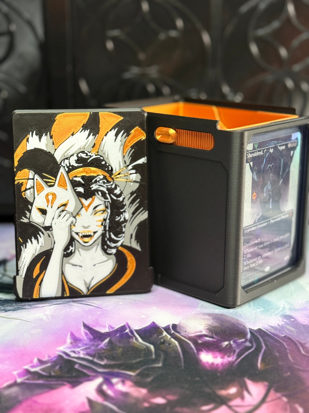 Black and gold Kitsune art panel beside the open deck box
