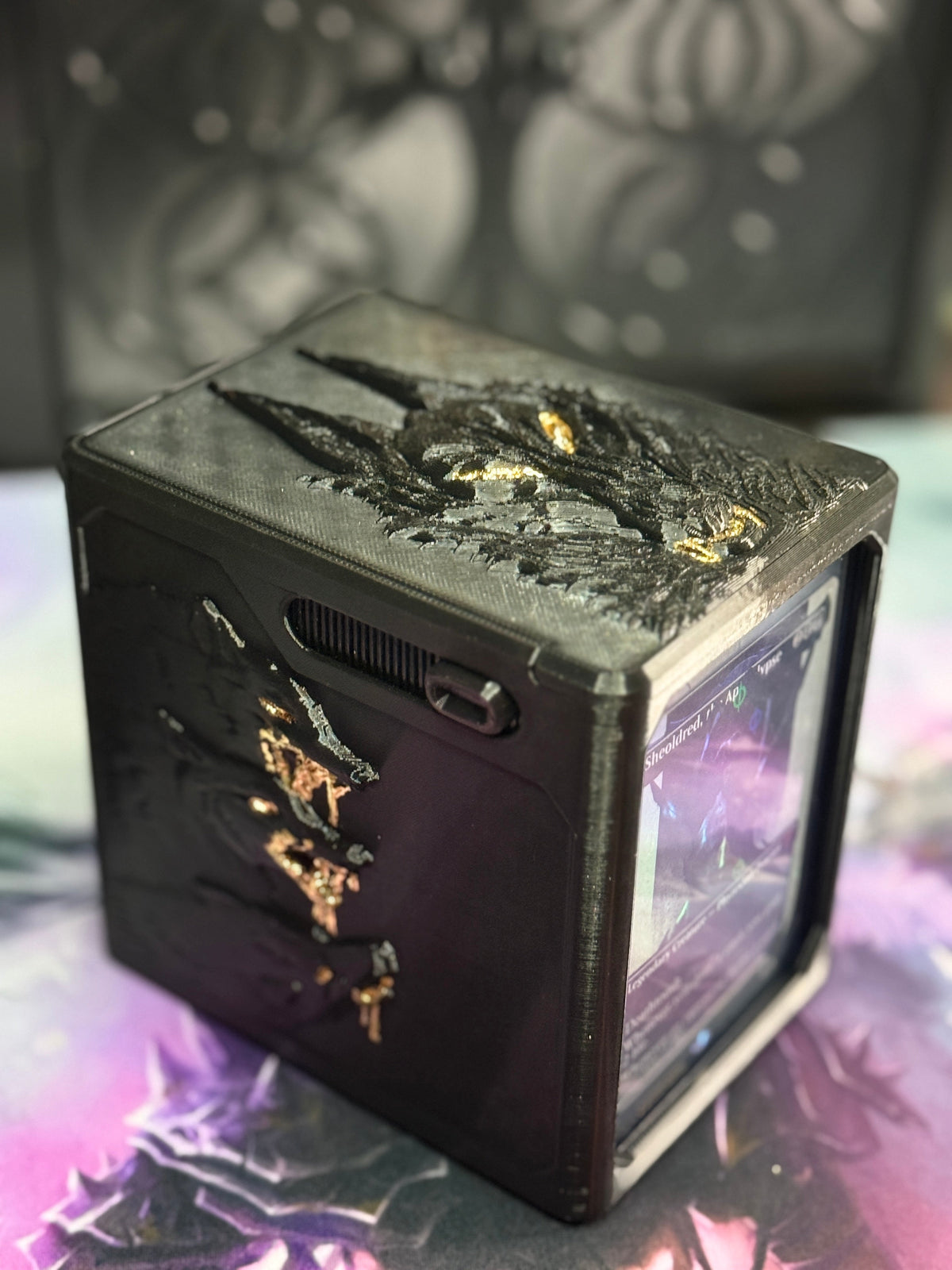 Top angle showing raised wolf artwork and gold accents