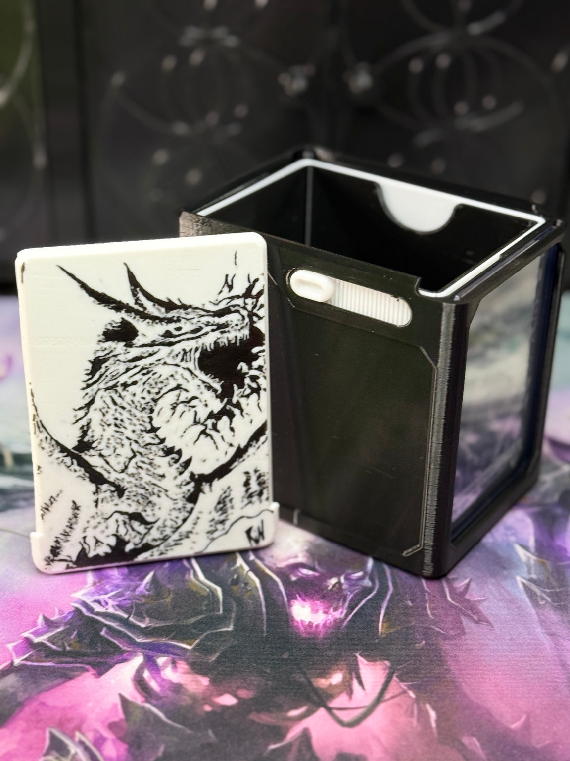 White dragon art panel beside the open black deck box
