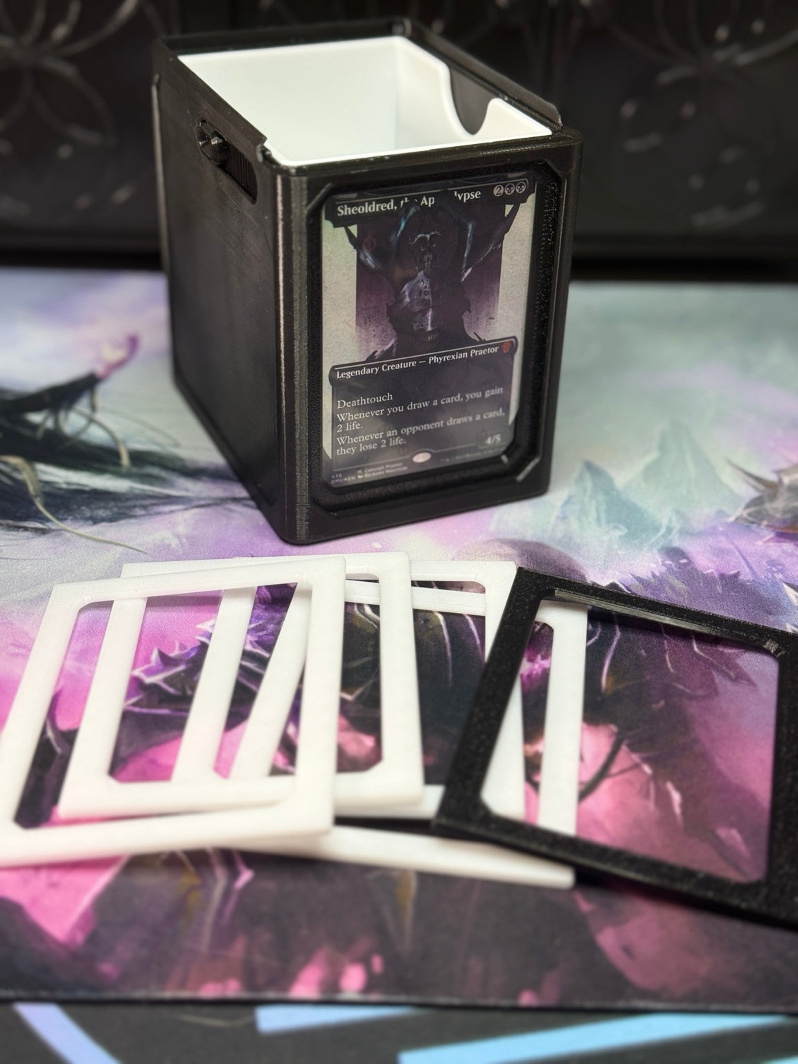 Black and white single/sleeve adapters shown beside an Alters By Rin deck box.