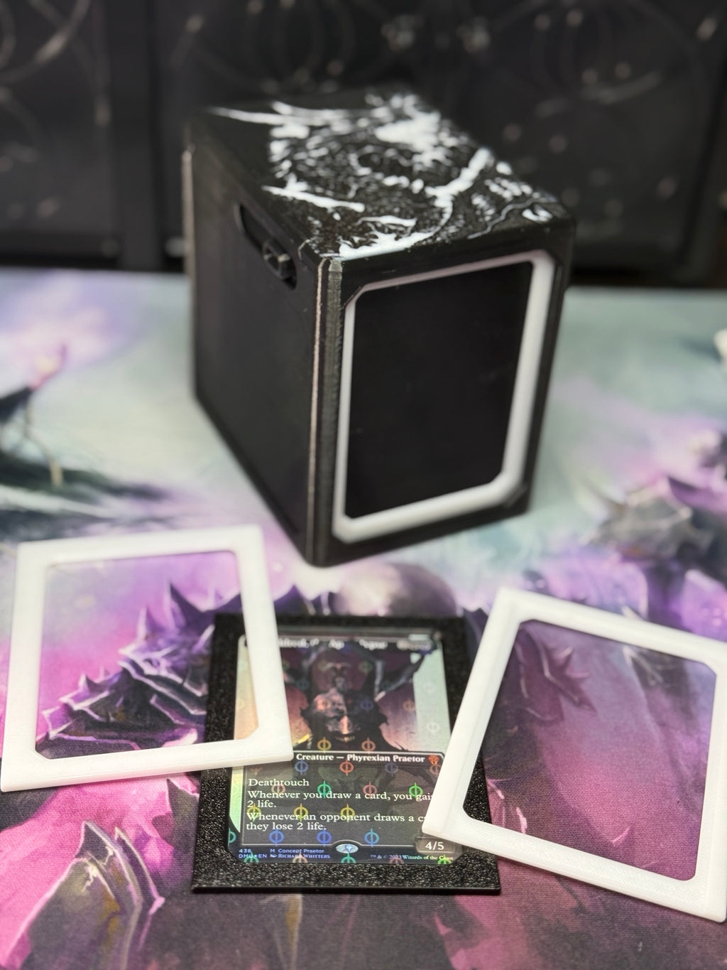 Alters By Rin deck box with black and white single/sleeve adapter pieces displayed around a sleeved trading card.