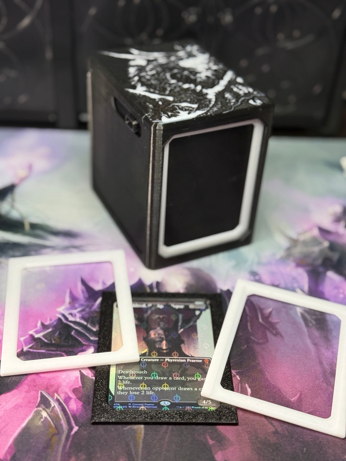 Alters By Rin deck box with black and white single/sleeve adapter pieces displayed around a sleeved trading card.