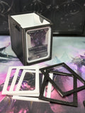 White single/sleeve adapter installed in an Alters By Rin deck box, with extra black and white adapters displayed in front.
