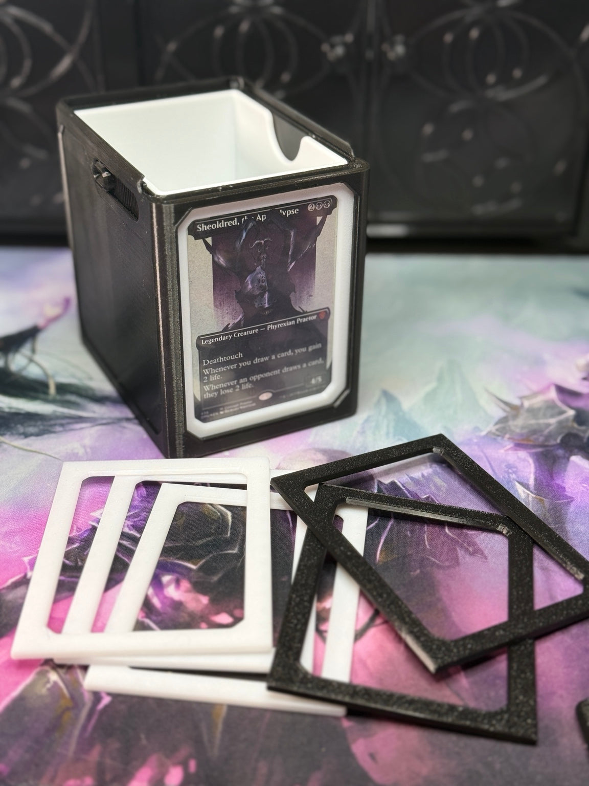 White single/sleeve adapter installed in an Alters By Rin deck box, with extra black and white adapters displayed in front.