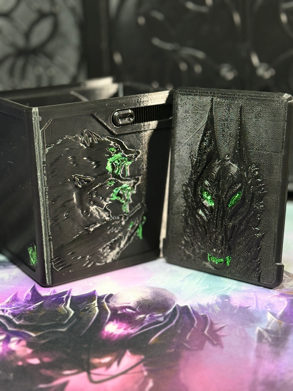 Black and green wolf relief art panel beside open box