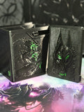 Black and green wolf relief art panel beside open box
