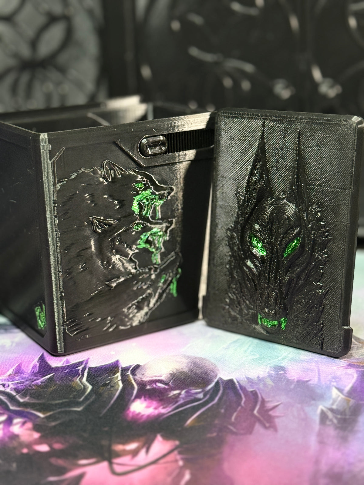 Black and green wolf relief art panel beside open box