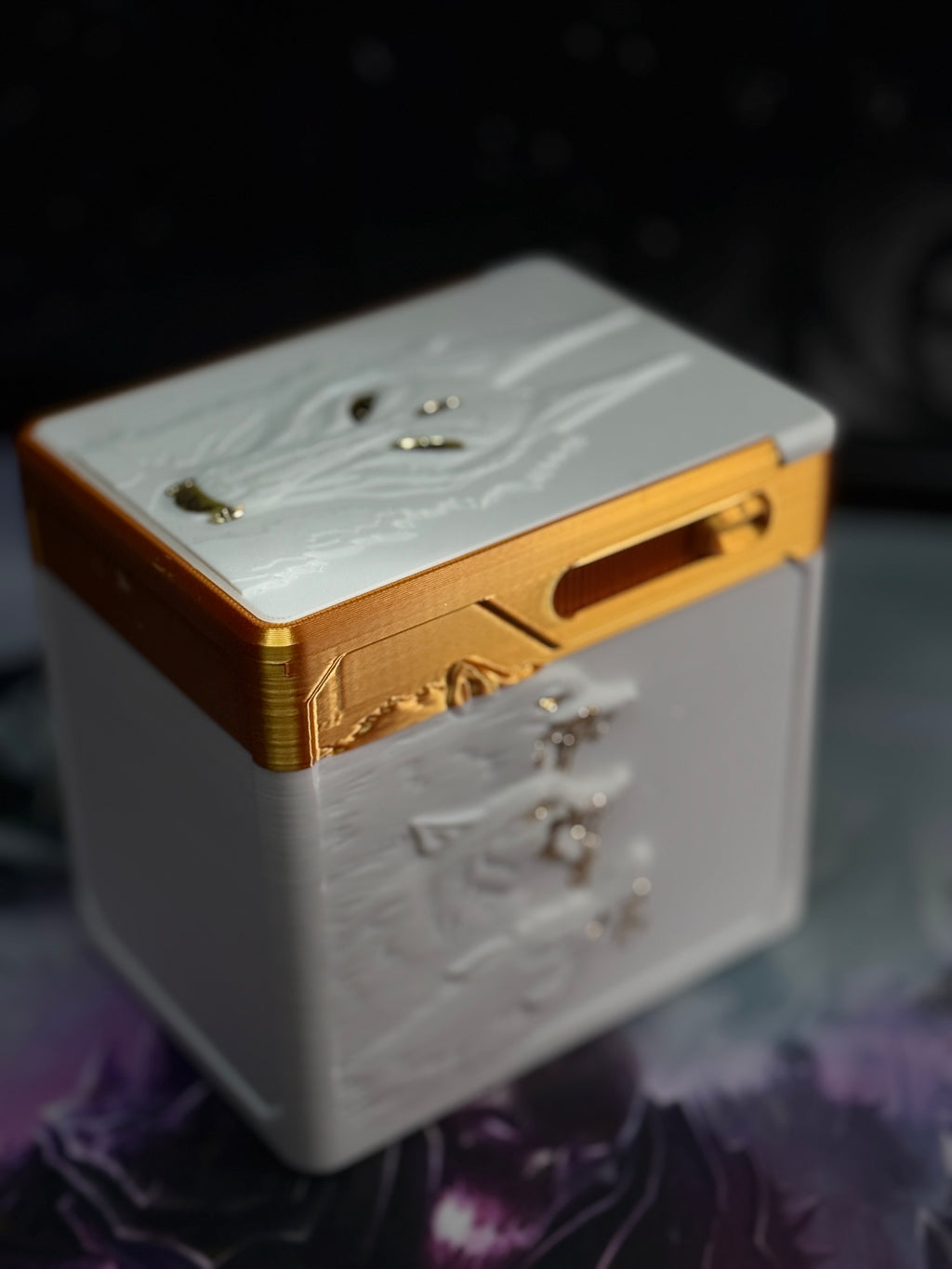 Top angle showing raised white wolf artwork and gold accents